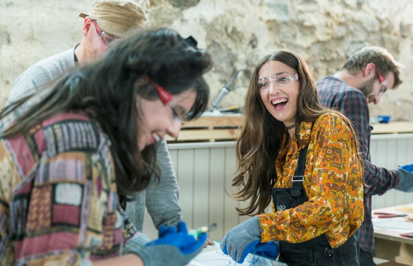 Two women working in a woodwork shop.