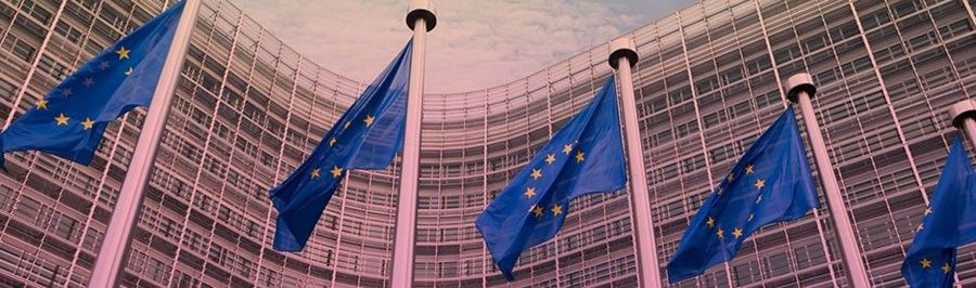 Five European Union flags outside the European Commission headquarters, Berlaymont in Brussels.