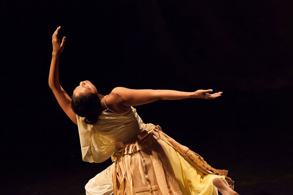 A woman in a dress dancing.