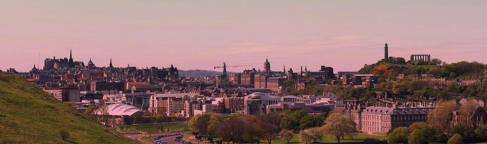 A panoramic view of Edinburgh with the Castle, Parliament and Holyrood Palace in view.
