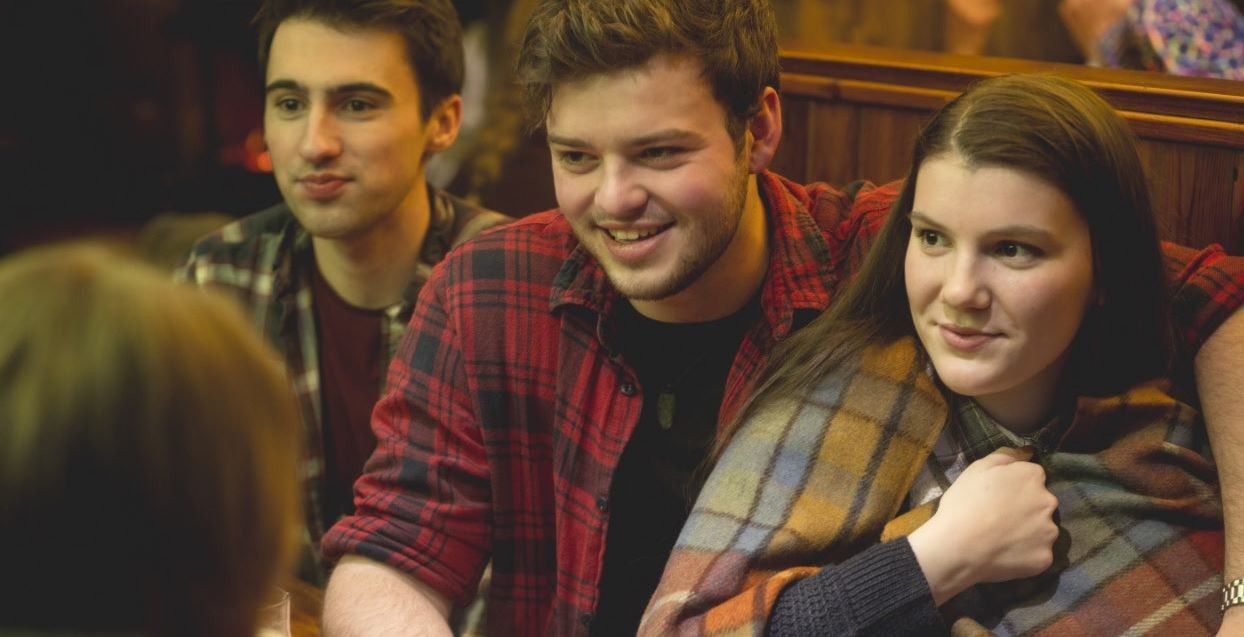 A group of people sitting in a pub.