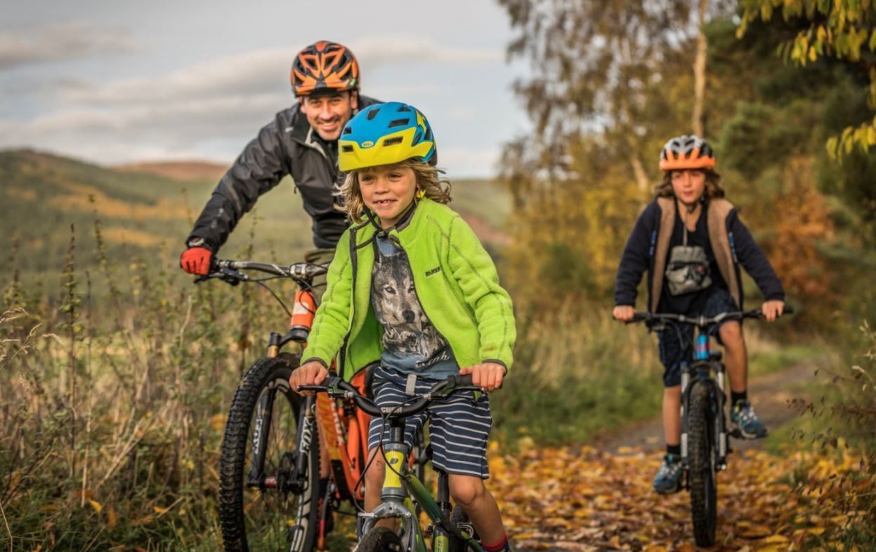 A family cycling in the countryside.